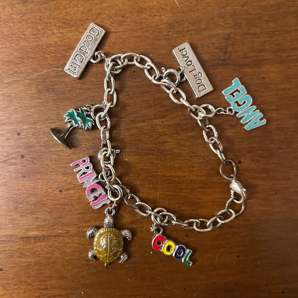 Silver metal charm bracelet with seven colorful charms, 6.5" long.